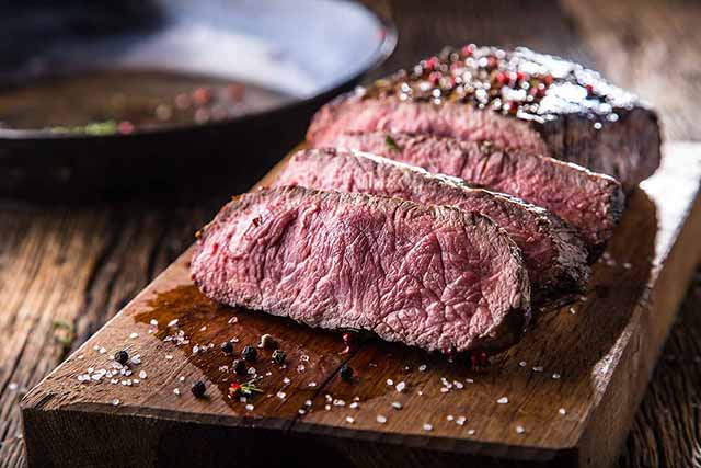 Chopped Bison Meat Steak On a Wooden Board.