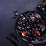 Purple Fruits In Two Bowls.