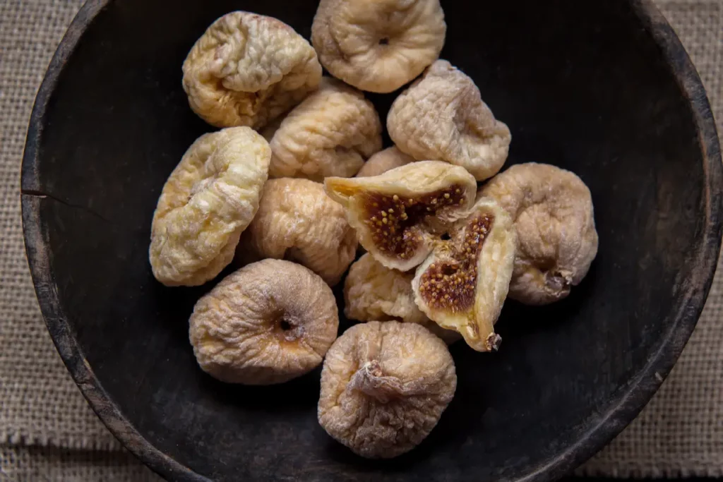 Dried figs in a black bowl.